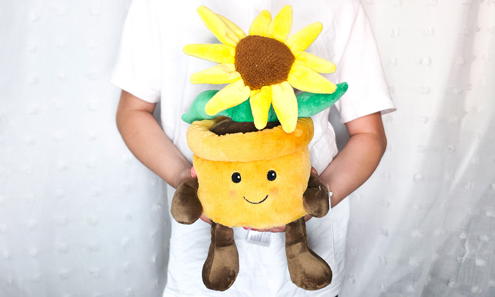 Child holding Warmies Yellow Flowerpot