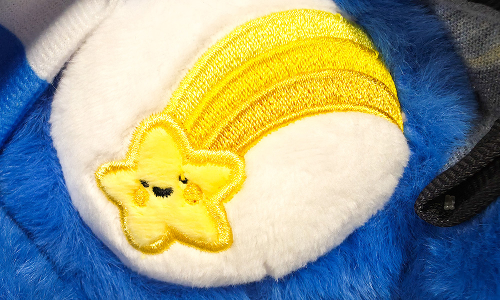 Care Bears x Harry Potter Wish Bear shooting star belly badge close up