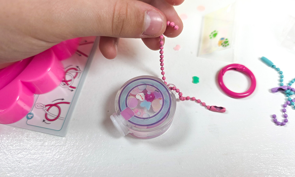 Style 4 Ever DIY Keychain Factory Set with aqua keyrings putting chain on bottle