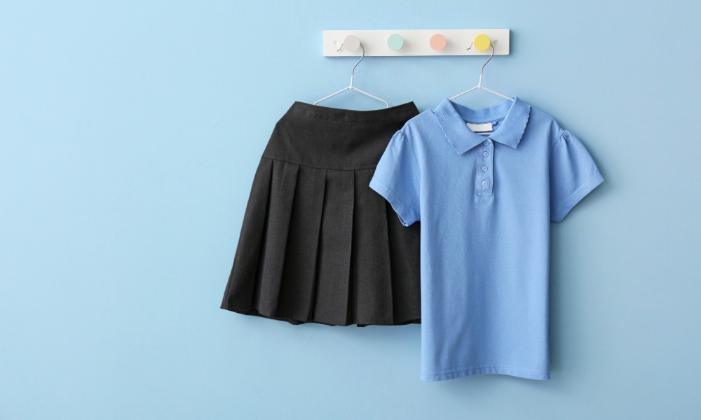 School uniform, bag and stationery on a desk representing the School Essentials Grant in Pembrokeshire
