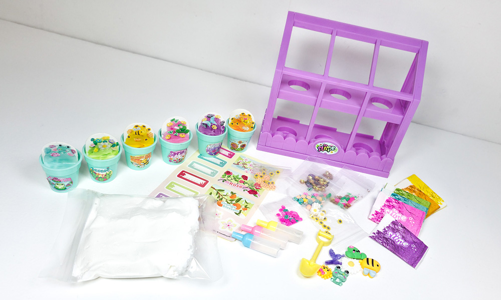 So Slime Flower Mini Garden contents laid out including six mini flowerpots, greenhouse display