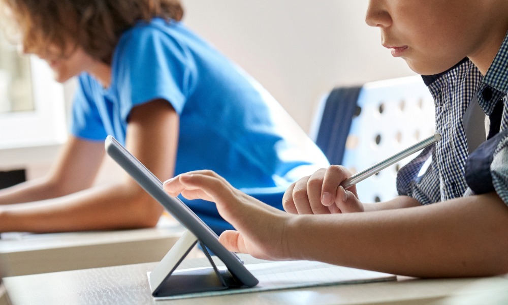 child diong school work on a tablet in Ceredigion on first day of term