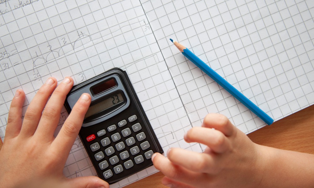 child working out maths sums at school in Swansea on first day of term
