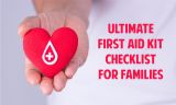 White First Aid Cross on Red Heart held in Mans Hand